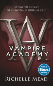 romance book cover for "Vampire Academy" by Richelle Mead, featuring a stylized 'V' shape overlapping a woman's face on a dark red background.