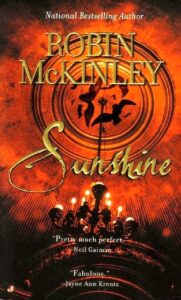Book cover for "Sunshine" by Robin McKinley, featuring a fiery orange and red background with a central chandelier and ornate, golden text. part of the Best vampire romance books list